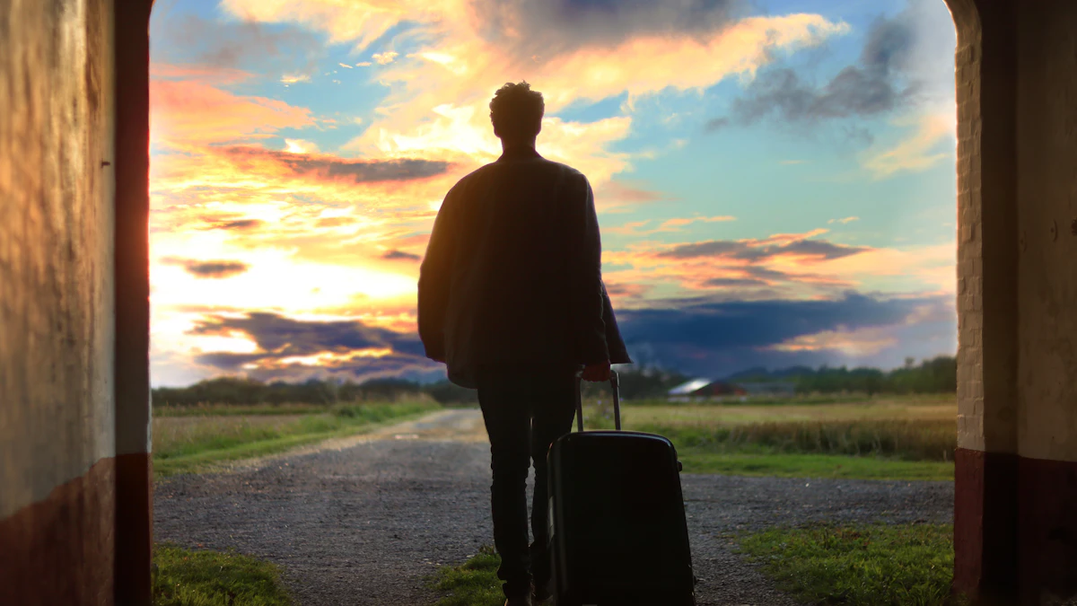 Traveler with a suitcase walking toward the sunset