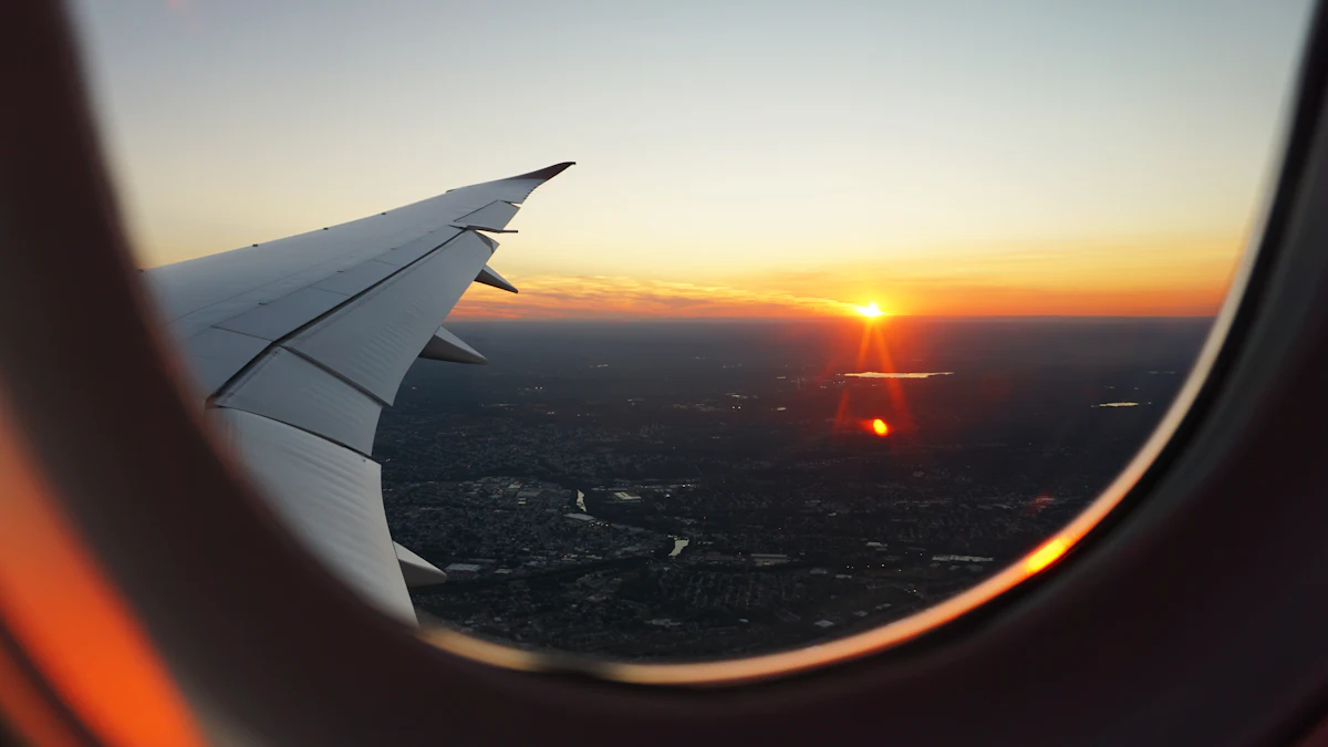 View of an airplane wing through the cabin window at sunset