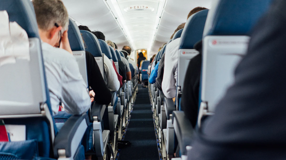 Passengers seated in an airplane cabin aisle
