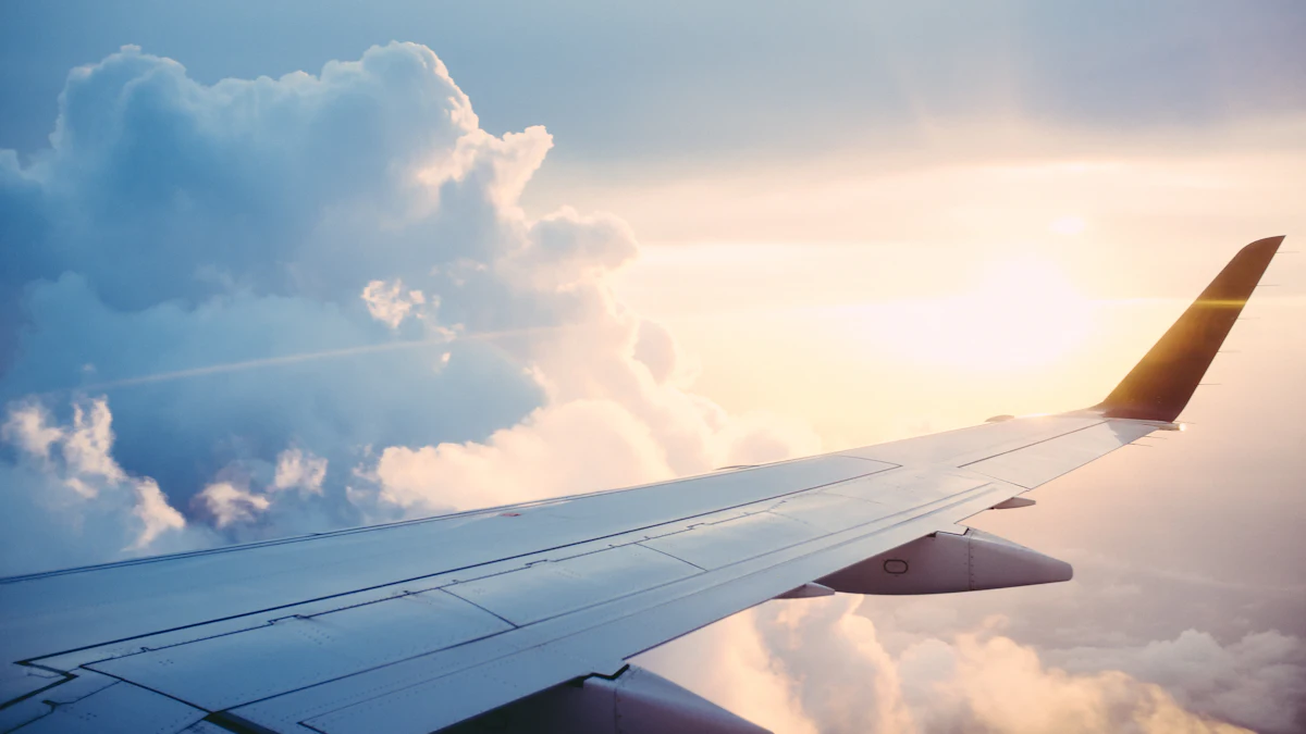 Airplane wing above the clouds at sunrise